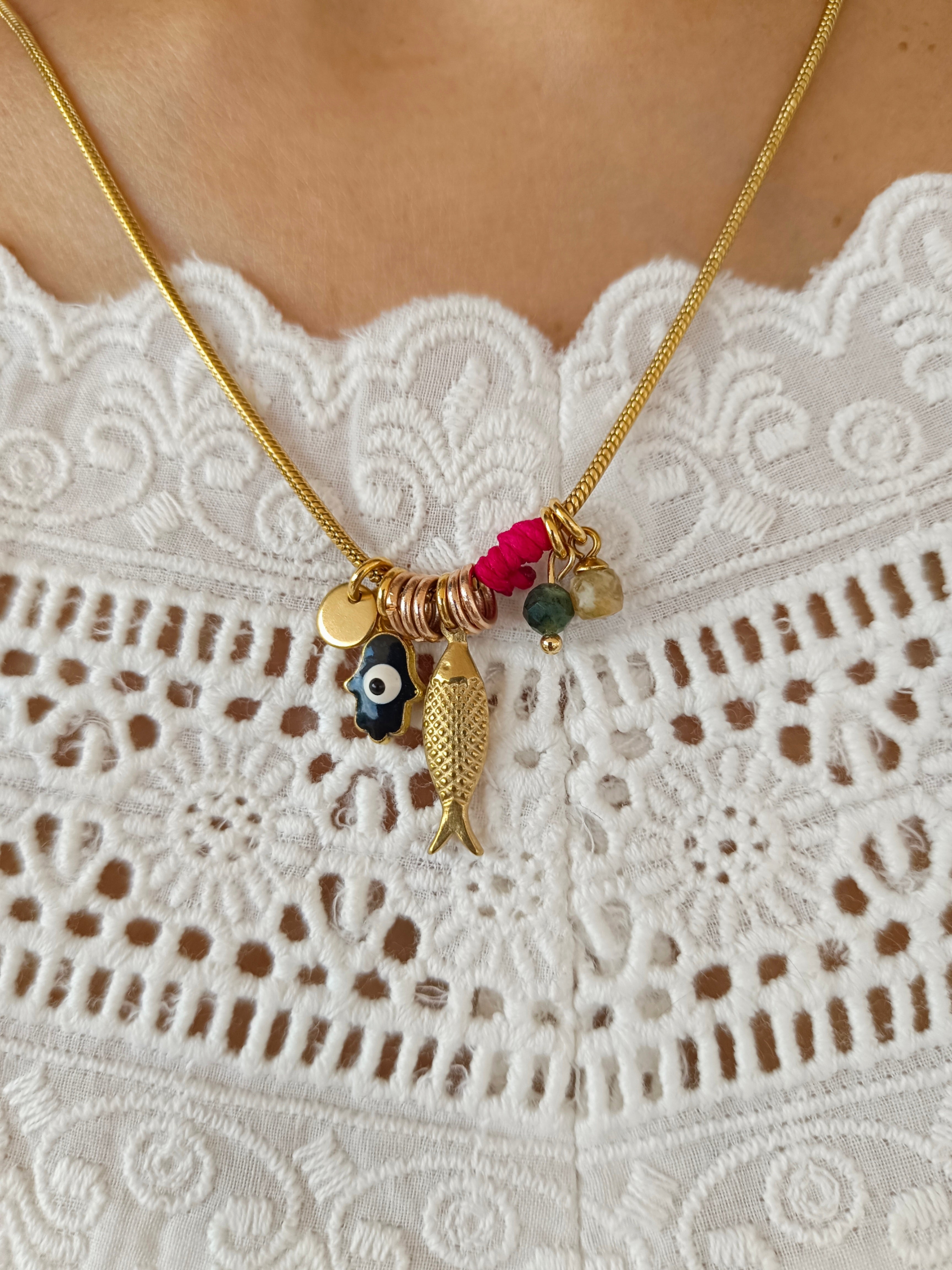 my eyes A rounded snake necklace with gold plating combined with pendants of blessing and protection