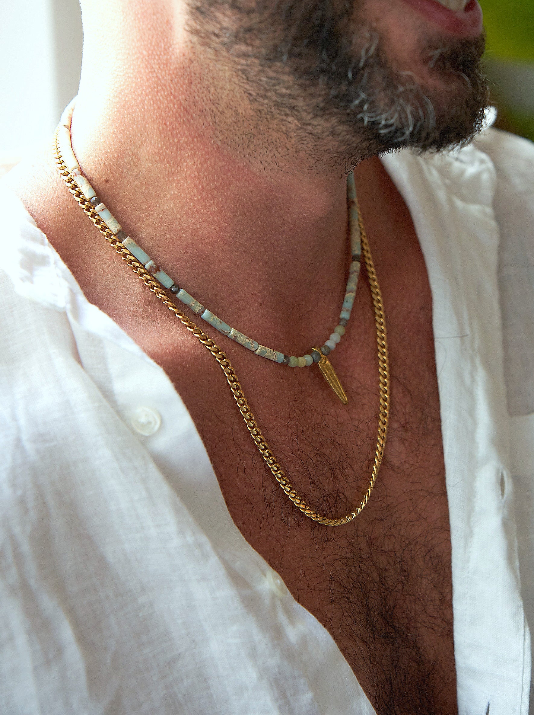 Juan | A necklace of blue jasper stones combined with a brass pendant of a dagger Juan 